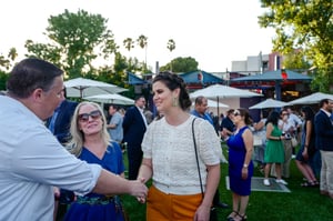 Guests converse and network at the Central City Association’s Elected Officials and Chiefs of Staff Reception at LA Plaza de Cultura y Artes in Downtown Los Angeles, engaging in conversation in a lively outdoor setting.