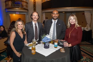 Guests gather and celebrate at the Central City Association’s holiday party, socializing in a festive indoor setting with warm lighting and seasonal décor.