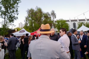 Guests converse and network at the Central City Association’s Elected Officials and Chiefs of Staff Reception at LA Plaza de Cultura y Artes in Downtown Los Angeles, engaging in conversation in a lively outdoor setting.